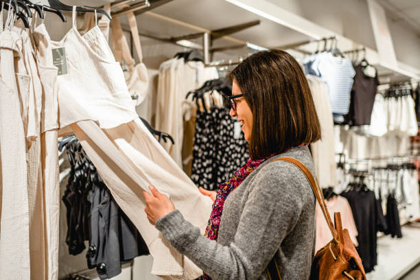istock Woman choosing clothes at a store 2154971477