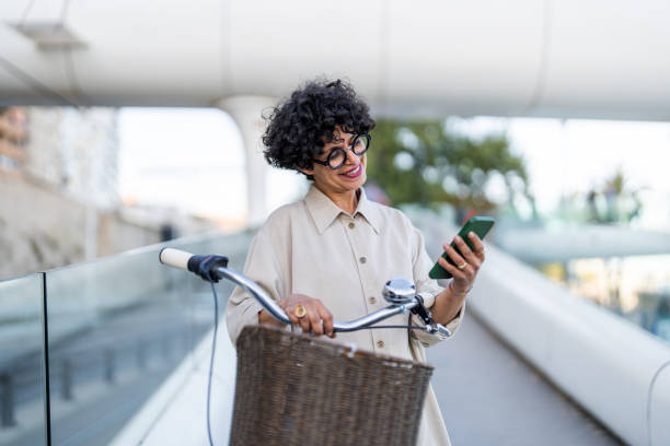 istock Professional Woman Texting by Bicycle in Urban Setting 2154971605