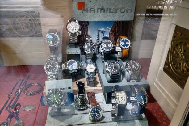 Bologna, Italy, May 15, 2024: Vibrant storefront display showcasing a variety of stylish hamilton watches, featuring multiple designs and styles. ideal for retail window presentations, the arrangement highlights craftsmanship and elegance, appealing to luxury watch enthusiasts.