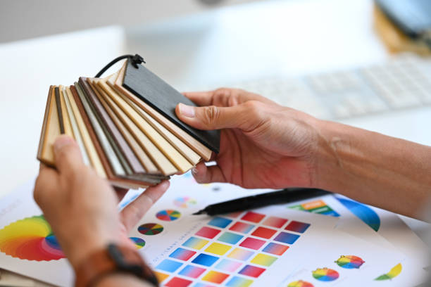 istock Close up hands of Interior designer choosing laminate floor samples at desk. Home design and renovation 2154972434