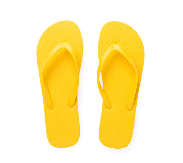 istock Bright yellow flip-flops isolated on white, top view 2154972593