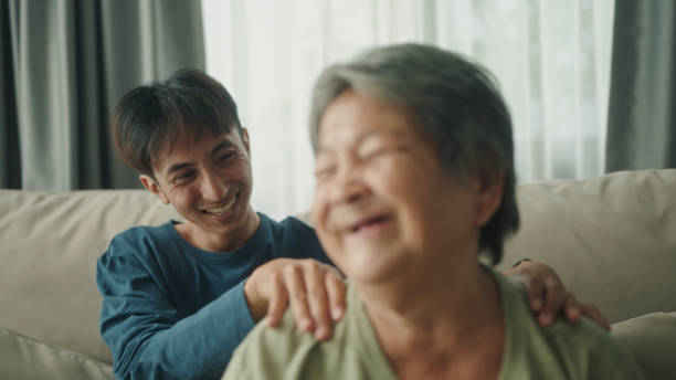 istock Young man taking care for elderly at home. 2154972785