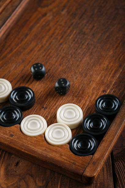 istock Backgammon. Game field in a backgammon with cubes and counters. Game concept. Board game. Hobby. Dice and checkers on the playing field for a game of backgammon. 2154972867