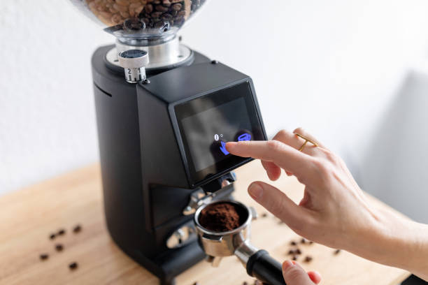 istock Woman barista make grinding coffee beans with machine 2154972905