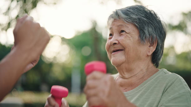 istock Senior woman and nurse exercise together. 2154973565