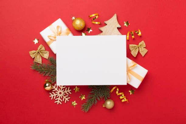 istock Greeting card mockup with christmas decor on color background, top view 2154973781
