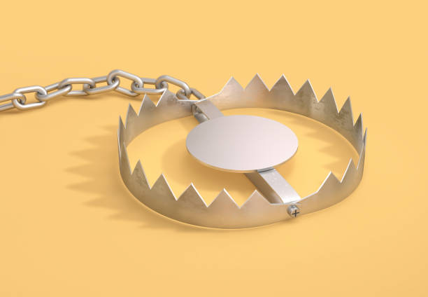 istock Open metal bear trap with metal chain on yellow background 2154973826