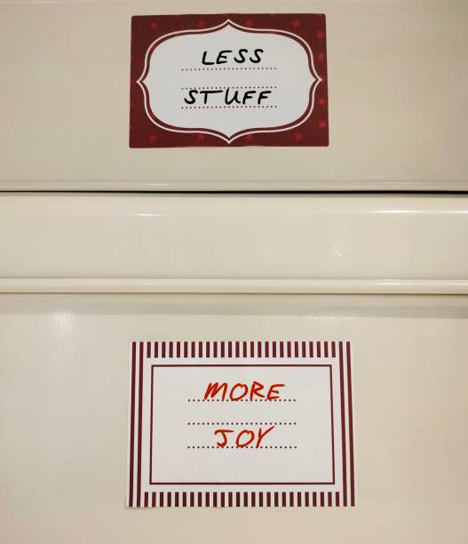 istock Storage boxes with handwriting on tag LESS STUFF = MORE JOY - concept of declutter your life, less possession leads to inner calm and peace of mind 2154974148