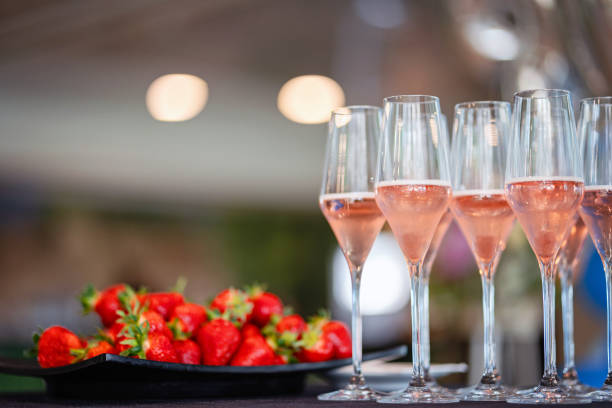 istock Strawberries and glasses with sparkling wine at a party 2154974449