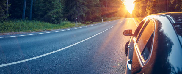 istock Panoramic view of the car on the asphalt highway on sunset. 2154975142