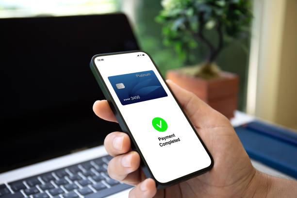 istock man hand phone with payment card wireless technology pos terminal 2154976642