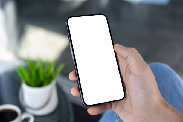 istock Male hand holding phone with isolated screen in cafe office 2154976747