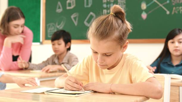 istock Stressful student focus on doing test while sitting in front of board. Pedagogy. 2154976928