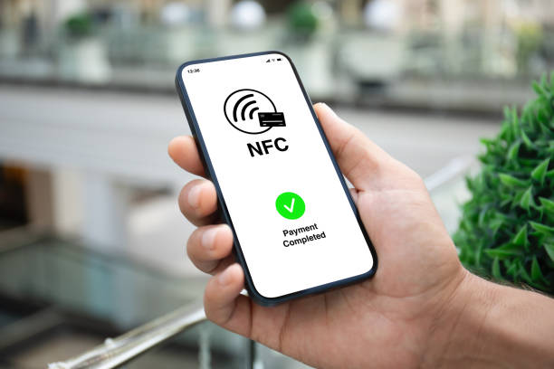 istock Male hand phone pay wireless technology nfc via pos terminal 2154977064