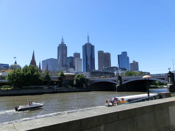 istock Riverside Cityscape with Boat and Bridge 2154977427