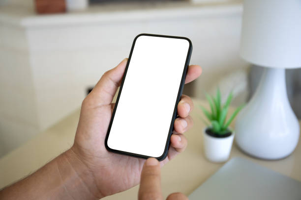istock Male hand hold phone with isolated screen background table home 2154977525