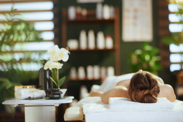 istock relaxed modern female in spa salon laying on massage table 2154977575