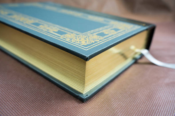 A green book with a gold plated edge
