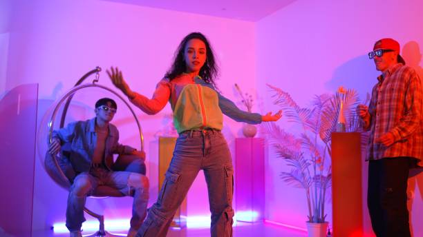 istock Happy dancer looking at camera while smart woman moving at rhyme. Regalement. 2154979340