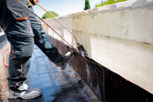 istock Worker using a gas burner, propane blowtorch to melt and arrange resin as unroll foil with bitumen 2154981423
