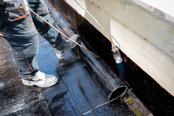 istock Worker using a gas burner, propane blowtorch to melt and arrange resin as unroll foil with bitumen 2154981456