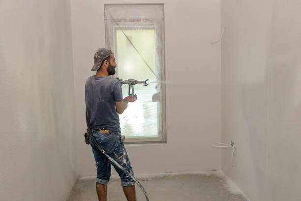 istock Worker is applying skim coating material to the wall before painting 2154982881