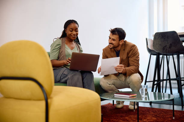 istock Happy colleagues cooperating while using laptop and going through business reports in the office. 2154984417