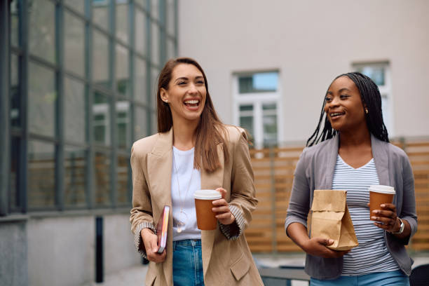 istock Cheerful female colleagues enjoying on a break at work. 2154984532