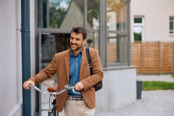 istock Happy businessman with bicycle leaving the office building. 2154984537