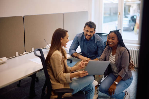 istock Happy start up team cooperating while using laptop in the office. 2154984658