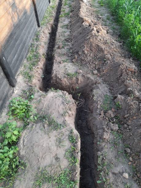 istock A trench dug in the ground for laying irrigation. 2154986363
