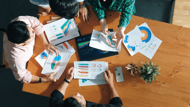 istock Top down view of business people analyze data together at meeting. Convocation. 2154986859