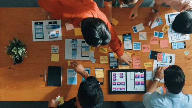 istock Top view of skilled business team writing idea on sticky note. Convocation. 2154987390