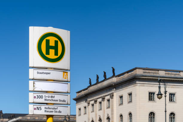 Germany, Berlin, Berlin Central, Unter Den Linden,  May 15, 2024 -Bus stop sign against building and clear sky