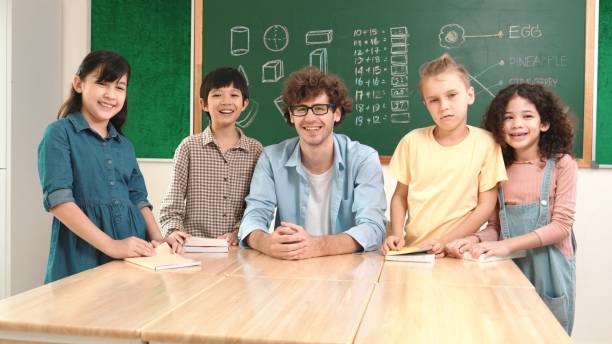 istock Teacher and student looking at camera while boy standing at board. Pedagogy. 2154992659