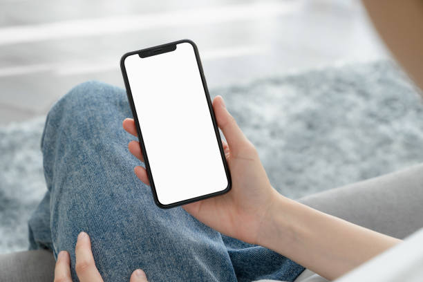 istock Hand holding smartphone mockup of blank screen for graphic display montage. 2154994090