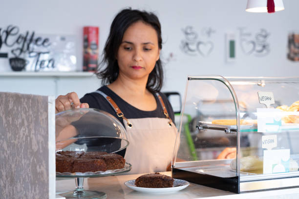 istock Arab woman working in an Arab sweets cafe 2154994819