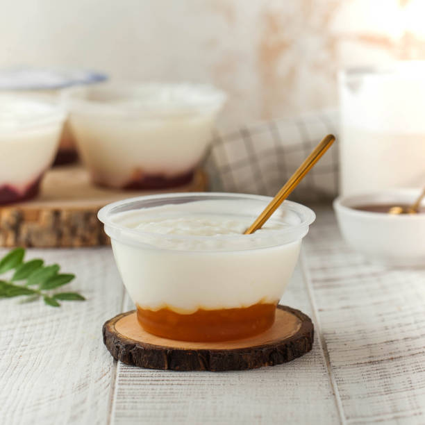 istock Delicious yogurt with peach and caramel in a plastic bowl 2154995838
