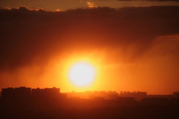 The red clouds illuminated by the setting sun created a beautiful scene above the urban skyline.