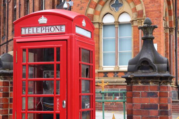 Leeds city, UK. Red telephone and Leeds General Infirmary in background.