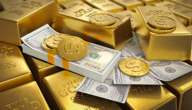 istock coins on banknotes and gold bars 2154999081
