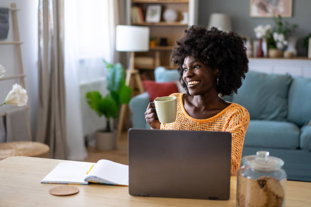 istock A woman having a coffee break while working at home 2154999731