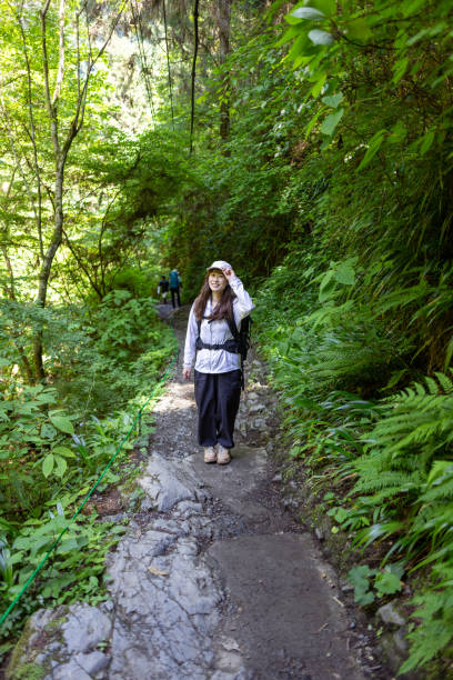 istock Female hiker walking up mountain 2155002056