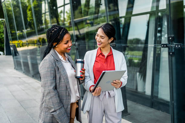 istock Young cheerful businesswomen using tablet 2155002949