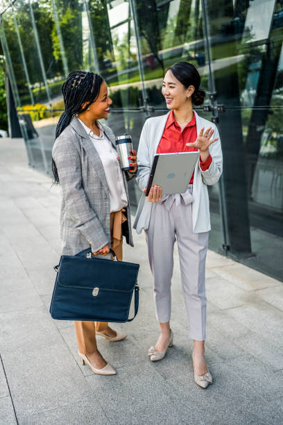 istock Young cheerful businesswomen using tablet 2155003104