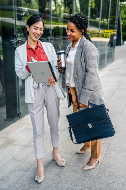 istock Young cheerful businesswomen using tablet 2155003191