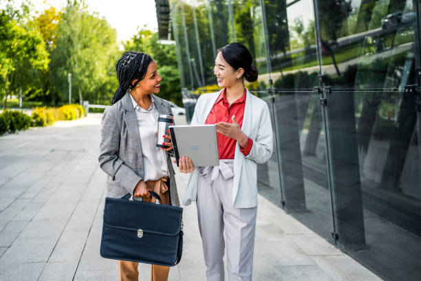 istock Multiracial businesswomen using tablet outdoors 2155003674