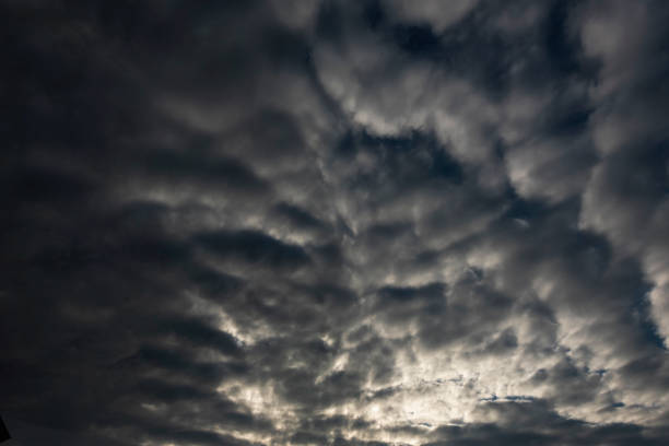 istock Dramatic dark storm rain clouds black sky background. Dark thunderstorm clouds rainny atmosphere. Meteorology danger windstorm disasters climate. Dark cloudscape storm disaster gloomy gray cloud sky 2155005284