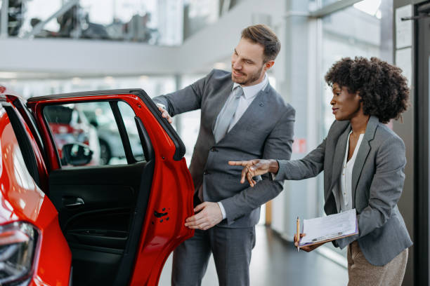 istock Salesperson and customer discussing a car 2155005940