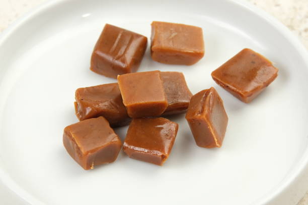 istock Caramel candies on a white background. 2155006254